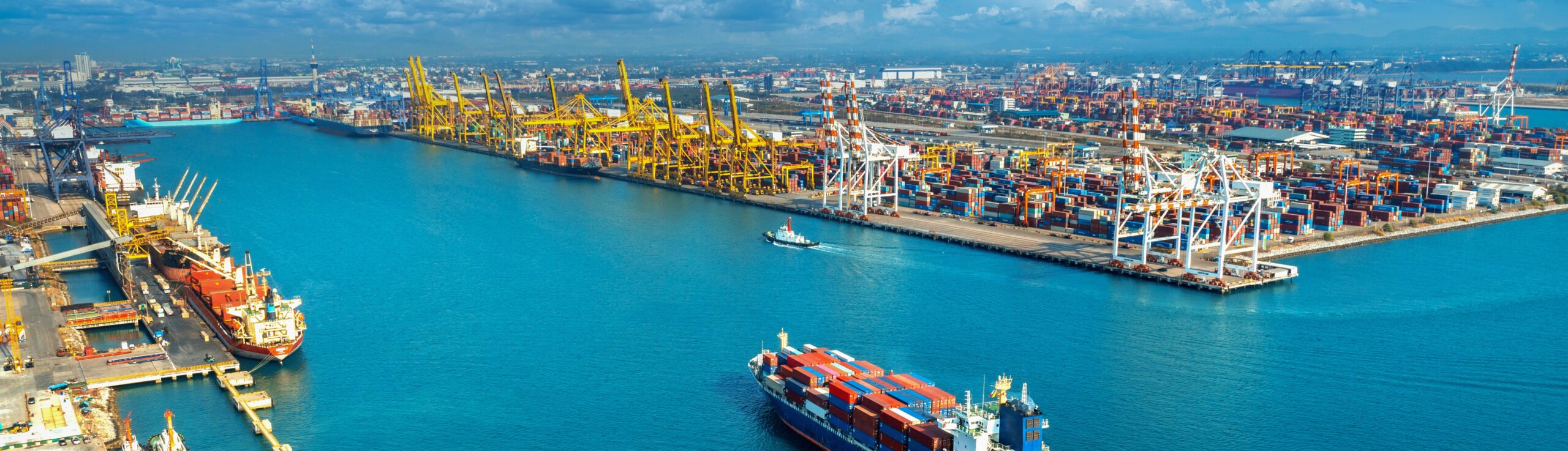 Aerial view of cargo ship and cargo container in harbor.